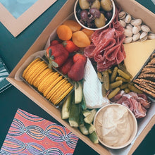 Load image into Gallery viewer, erves 2 to 5 people. Intimate Grazing Boxes include a range of fresh, high-quality produce to enjoy on any given occasion and contains: Cheese - one hard, one soft Cured meat (100g - upgrade includes additional 100g) Dip - one variation Antipasti items, dried and fresh fruit (assorted) Indulge alone or give someone the PERFECT gift, hand delivered and ready to enjoy. Include a premium bottle of West Australian wine or Champagne at checkout.