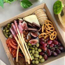 Load image into Gallery viewer, erves 2 to 5 people. Intimate Grazing Boxes include a range of fresh, high-quality produce to enjoy on any given occasion and contains: Cheese - one hard, one soft Cured meat (100g - upgrade includes additional 100g) Dip - one variation Antipasti items, dried and fresh fruit (assorted) Indulge alone or give someone the PERFECT gift, hand delivered and ready to enjoy. Include a premium bottle of West Australian wine or Champagne at checkout.