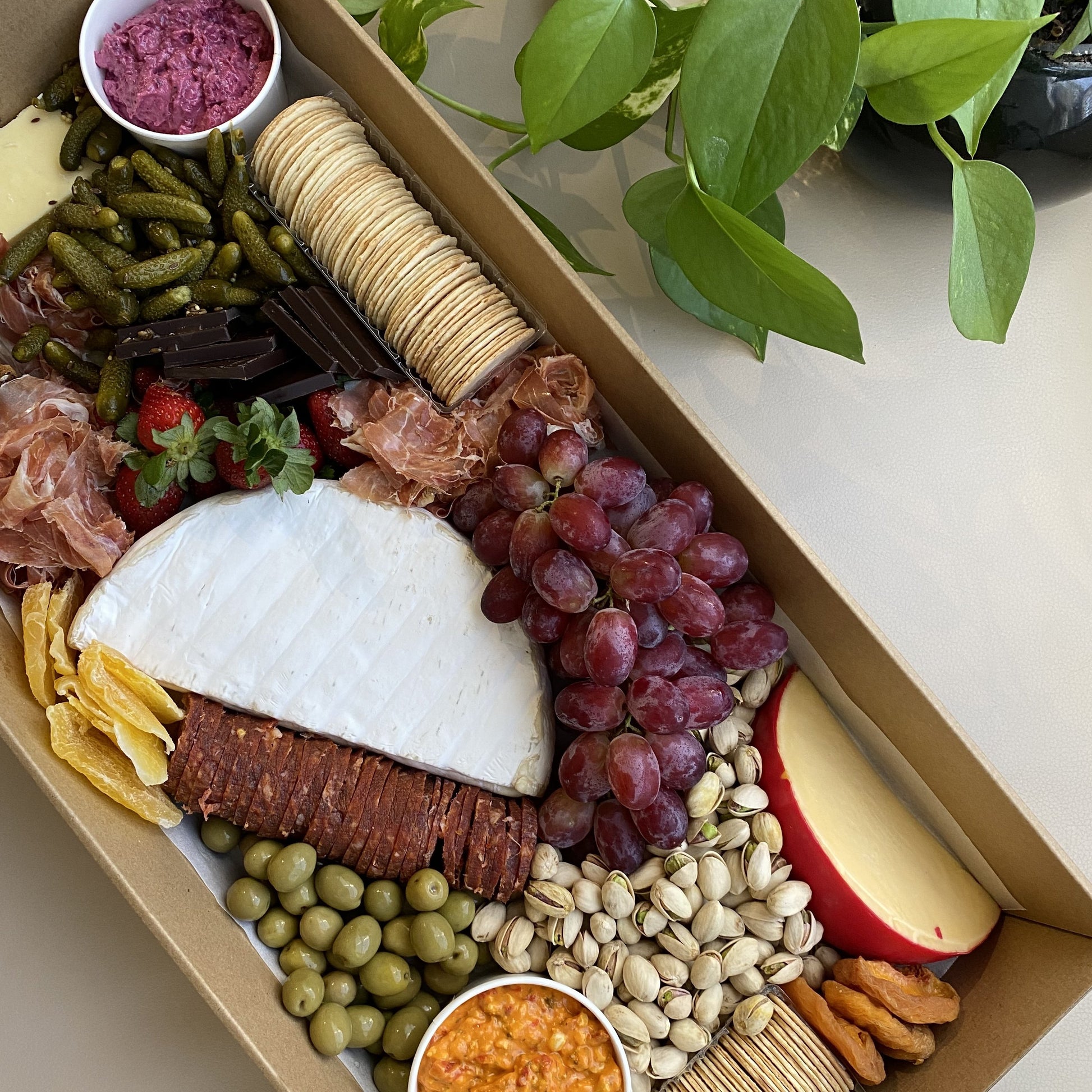 Serves up to 15 people.   Large Grazing Boxes help take the stress out of catering your next casual or formal event and suitable for a range of different occasions and includes:  Cheese - two hard, two soft Cured meat (300g two varieties - upgrade includes additional 200g) Dip - two variations Antipasti items, dried and fresh fruit (assorted) Including a substantial range of high-quality, locally sourced produce consisting of premium cheese, cold meats, nuts and gluten (unless specified).