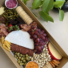 Load image into Gallery viewer, Serves up to 15 people.   Large Grazing Boxes help take the stress out of catering your next casual or formal event and suitable for a range of different occasions and includes:  Cheese - two hard, two soft Cured meat (300g two varieties - upgrade includes additional 200g) Dip - two variations Antipasti items, dried and fresh fruit (assorted) Including a substantial range of high-quality, locally sourced produce consisting of premium cheese, cold meats, nuts and gluten (unless specified).
