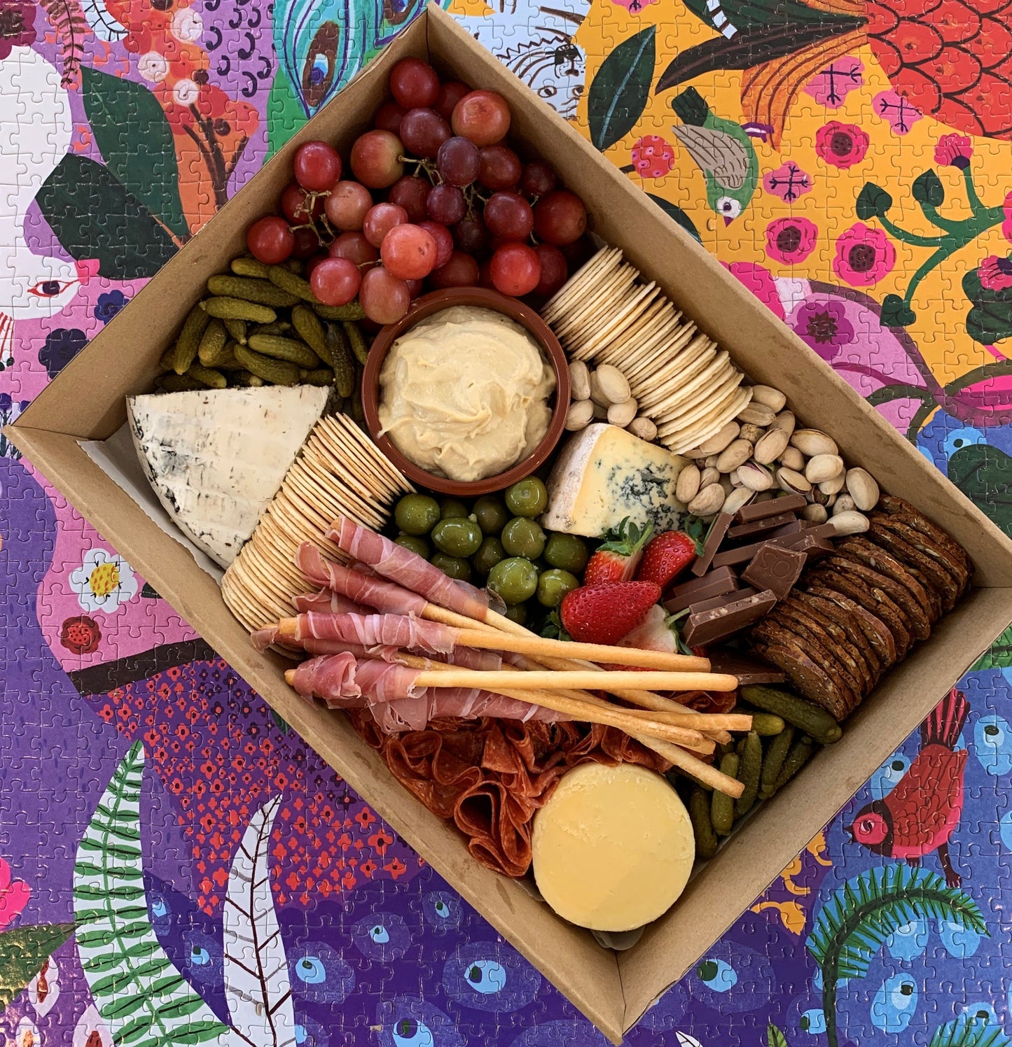 Serves up to 8 people.  Medium Grazing Boxes are an intelligent way to conveniently cater any casual or formal event or occasion and contains:  Cheese - two hard, one soft Cured meat (200g two varieties - upgrade includes additional 150g) Dip - two variations Antipasti items, dried and fresh fruit (assorted) Including a substantial range of high-quality, locally sourced produce consisting of premium cheese, cold meats, nuts and gluten (unless specified).